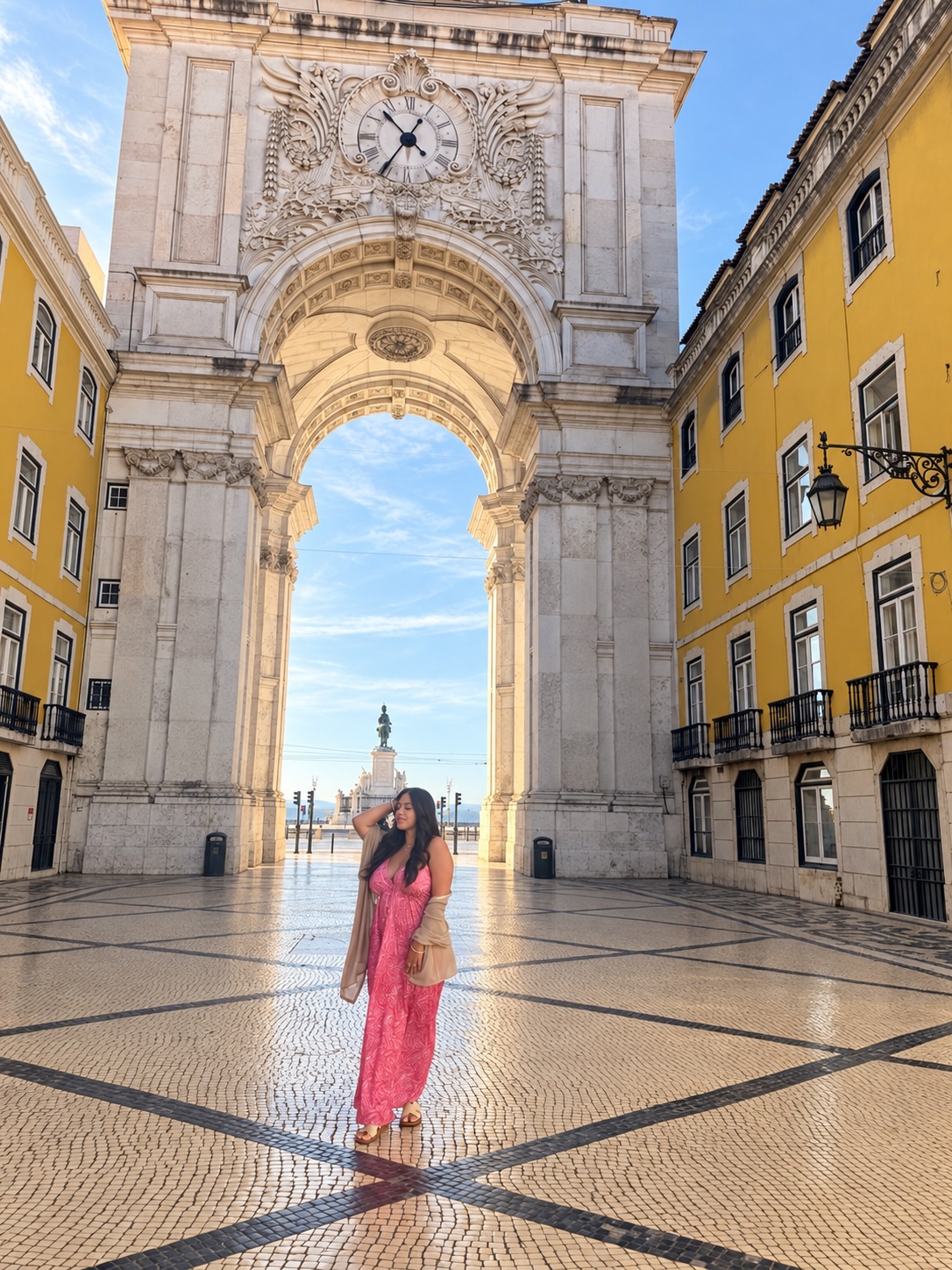 Jazmin in a pink dress beneath the Arco da Rua Augusta in Lisbon, Portugal